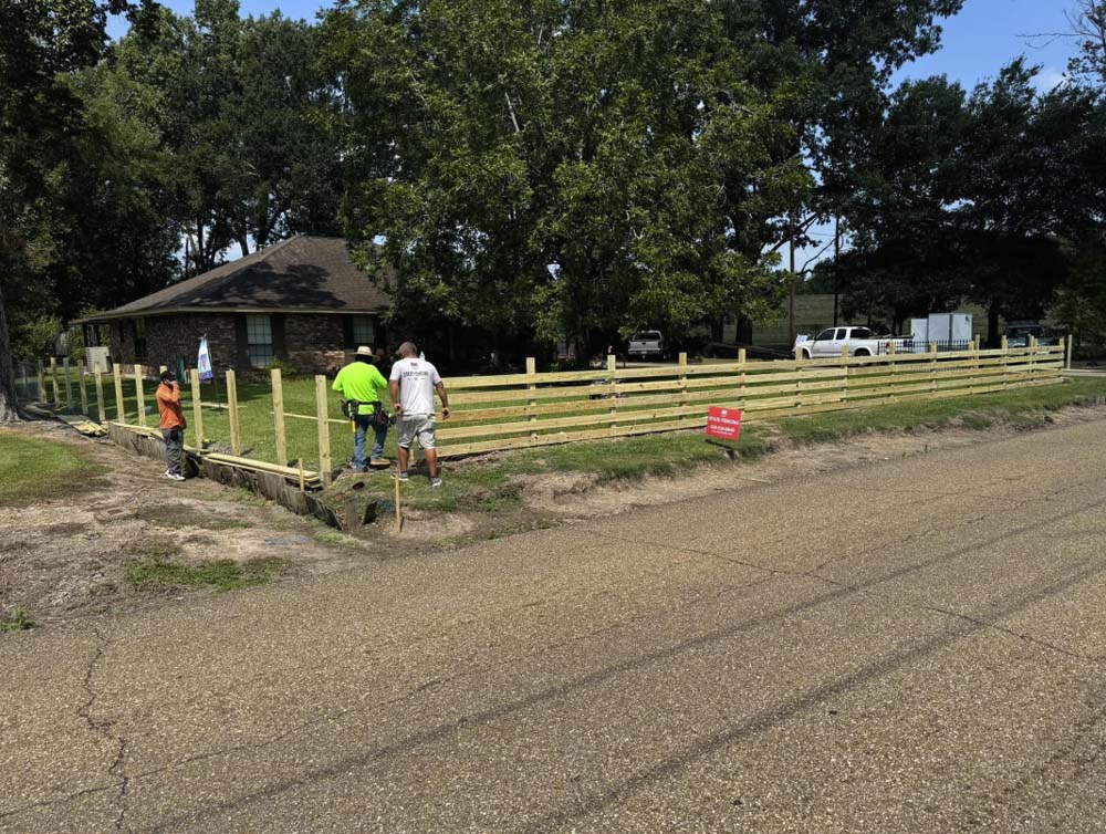 Professional wood fence installation along a residential property line in Baton Rouge