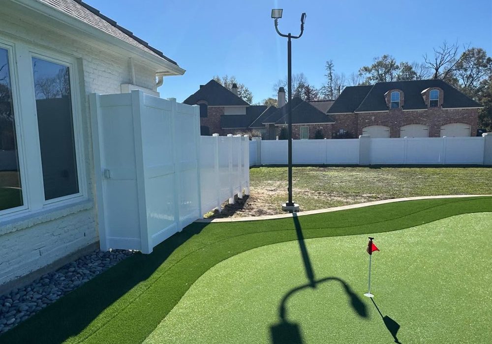 White vinyl privacy fence installed around a residential backyard in Baton Rouge