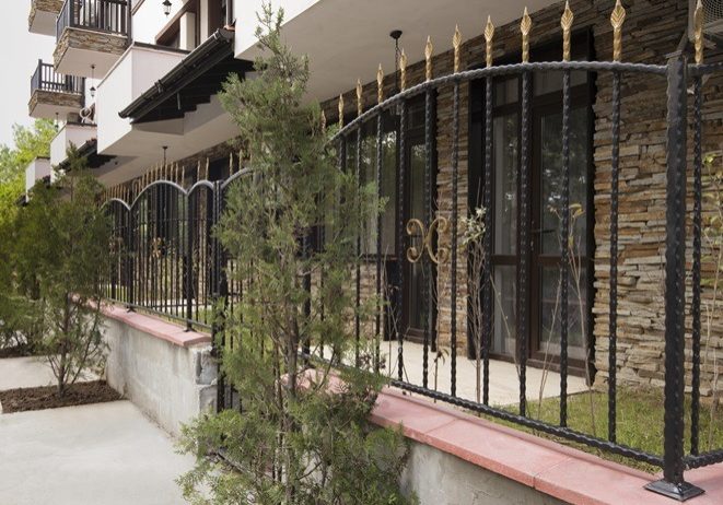 Wrought iron fence on modern building exterior