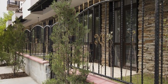 Wrought iron fence on modern building exterior